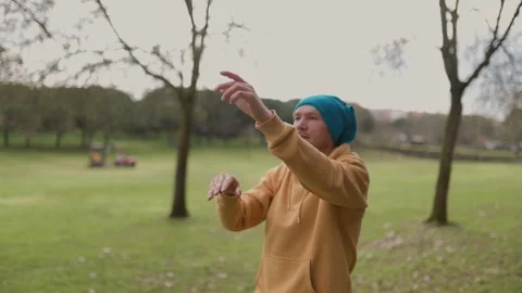 Man practicing tai chi chuan in public park Stock Footage 316835714