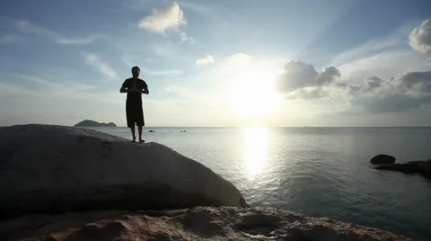 Man Practicing Tai Chi By The Ocean Video stock 25951182