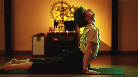 Man practicing yoga alone in yoga class Stock Footage 55534259