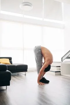 Man Practicing Yoga At Home Doing Sun Salutation Routine Stock Photos