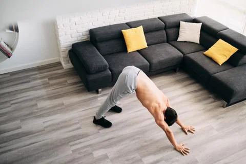 Man Practicing Yoga At Home Doing Sun Salutation Routine Stock Photos