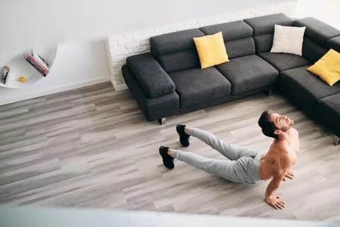 Man Practicing Yoga At Home Doing Sun Salutation Routine Stock Photos