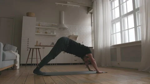 Man Practicing Yoga at home Stock Footage 149479732