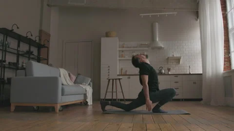 Man Practicing Yoga at home Stock Footage 150673142