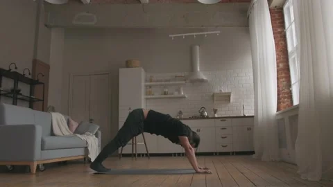 Man Practicing Yoga at home Stock Footage 153124396