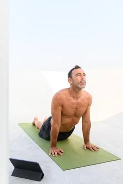 Man practicing yoga online class - copyspace Stock Photos