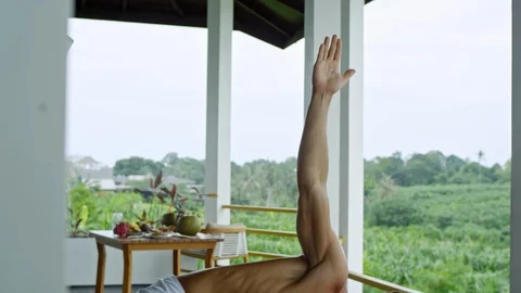 Man Practicing Yoga Poses on Balcony Stock Footage 92107597