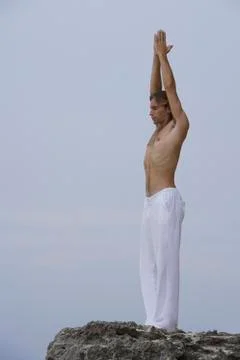 Man practicing yoga on rocks Stock Photos