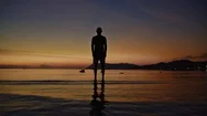 Man Practicing Yoga In The Sea During Sunset Stock Footage