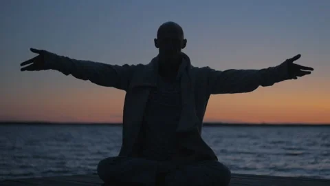 Man Practicing Yoga At Sunset By The Sea. Lotus Pose Stock Footage 117194565