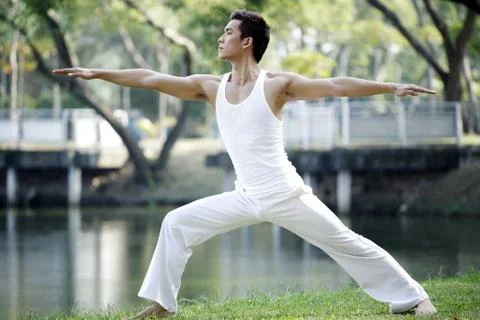 Man practising yoga in the park Stock Photos