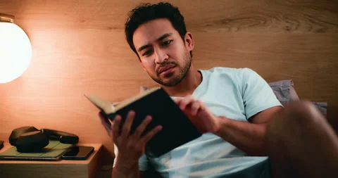 Man, praise and reading bible in bedroom, scripture and Christian with belief Видео 323294674