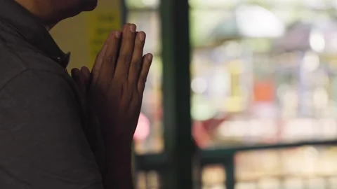 Man in prayer, hands joined together, expressing devotion and reverence Stock-Footage 244388058