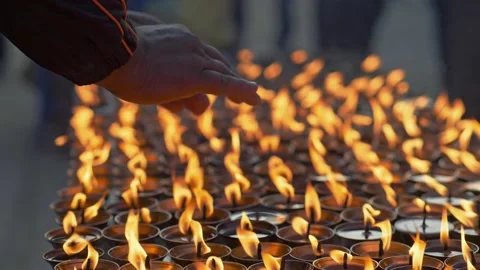 Man prayer warming his hands over candles. Hands of prayer and burning candles Video stock 221518413
