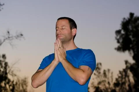 Man praying alone outside. Stock Photos
