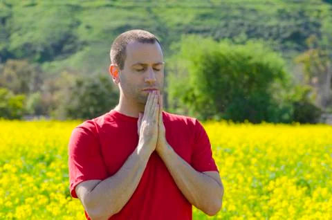 Man praying alone outside. Stock Photos