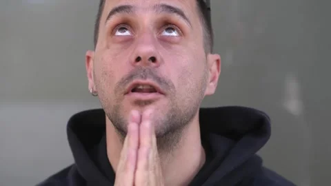 Man praying and looking up at the sky with hope Stock Footage 318583516