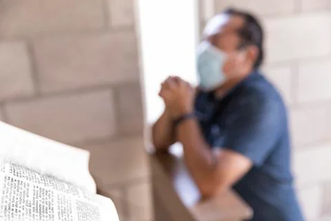 Man praying with face mask with face masks Stock Photos