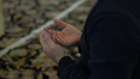 Man praying to God with open hands in mosque Stock Footage 268359628