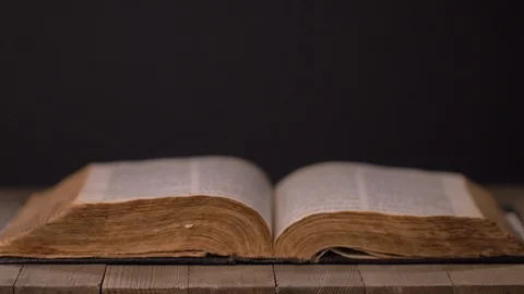 Man Praying With Hands over Old Bible Video stock 129712847