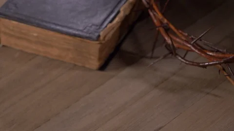 Man Praying With Hands On Top Of Table with Bible and Crown of Thorns Stock-Footage 129703785