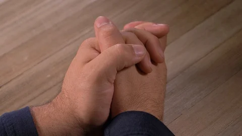 Man Praying With Hands On Top Of Table Video stock 129703818