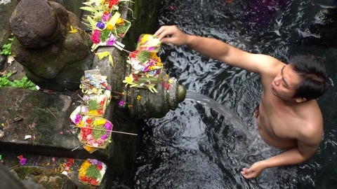 Man praying at holy spring water temple in Bali, Indonesia. Stock Footage 74399147