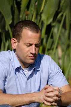 Man praying outside. Stock Photos