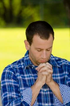 Man praying in a park Stock Photos