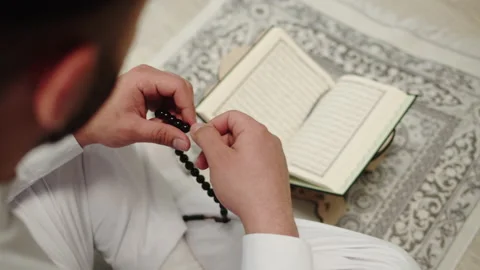Man praying, reading quran close-up, islamic religion. Religious holiday Ramadan Stock Footage 175403020