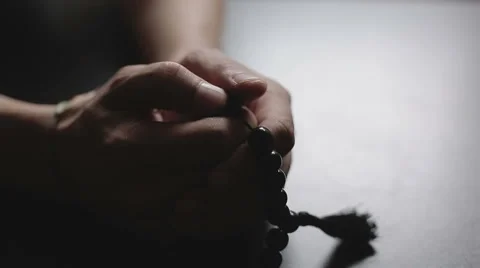 Man praying with rosary Stock Footage 49712429