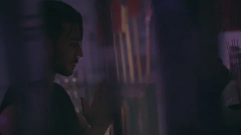 Man praying to statues and then looking up Stock Footage 279828612