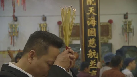 Man Praying at Temple Stock Footage 77736154