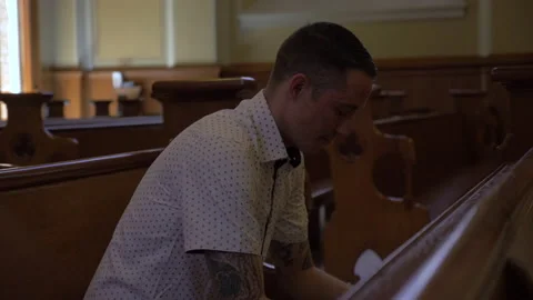 Man Praying While Sitting in Pews Stock Footage 208730665