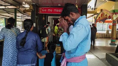 A man prays before the god with devotion inside the temple to seek blessings Video stock 243577854