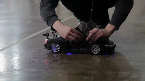 Man prepairing RC car for race Stock Footage 73098022