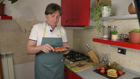 A man prepare a typical dish of Puglia friselle Stock Footage 156761232