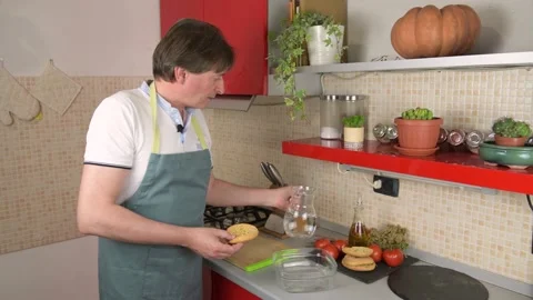 A man prepare a typical dish of Puglia friselle, pouring water to moisten frisa Stock Footage 156903136