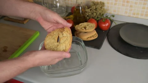 A man prepare a typical dish of Puglia friselle: taking one moisten frisa Stock Footage 156905356