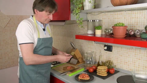 A man prepare typical dish of Puglia friselle: dry bread with tomatoes, oregano Stock Footage 156905428