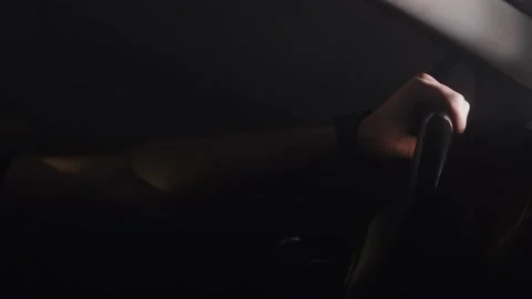 Man prepared for a night drive, close up of a hand on steering wheel. Stock Footage 145908060