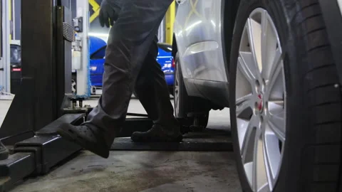 Man prepares to activate vehicle position fixation mechanism Stock Footage 317648626
