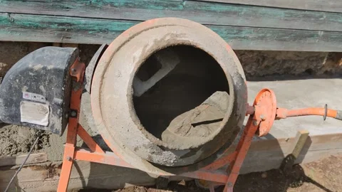 A man prepares cement mortar for the blind area in a concrete mixer. Stock Footage 197042459