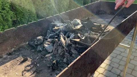 Man prepares charcoal to cook kebabs. Video stock 198014331