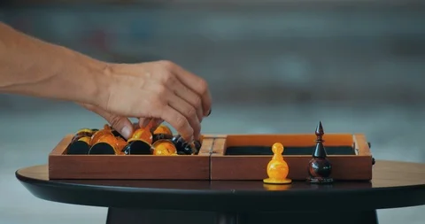 Man prepares to chess game and put out the figures at chessboard Stock Footage 104619873