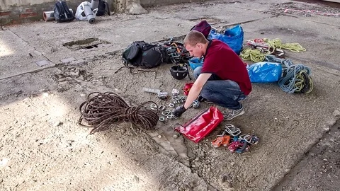 Man prepares climbing equipment Stock Footage 113614784