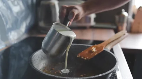 A man prepares a cream sauce Stock Footage 131495788