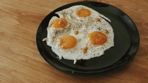 Man prepares eggs in a frying pan. making himself breakfast. Stock Footage 151690575