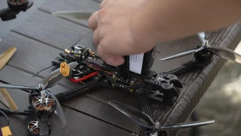 A man prepares an FPV drone before a flight Stock Footage 292007474