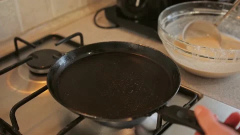 A man prepares himself breakfast in the kitchen, delicious pancakes Stock Footage 151690281